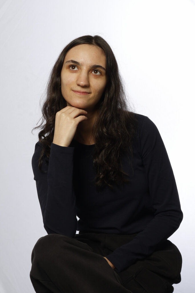 portrait a a young women with her hand under her chin