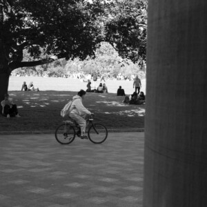 A women riding her bike on campus
